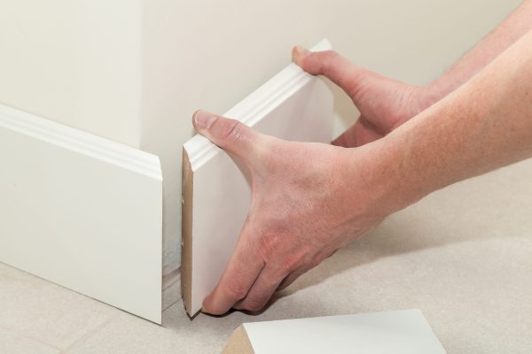 man-putting-new-skirting-board-in-house-2025-10-11-03-41-04-utc